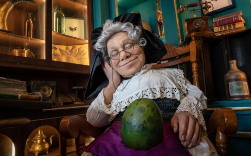 Madame Freudenreich mit einem Dino-Ei auf ihrem Schoß