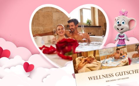 Pärchen in der Badewanne mit einem Glas Sekt