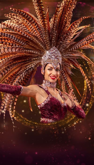 A dancer wearing a glamorous feather headdress at the Dinner-Show at Europa-Park.