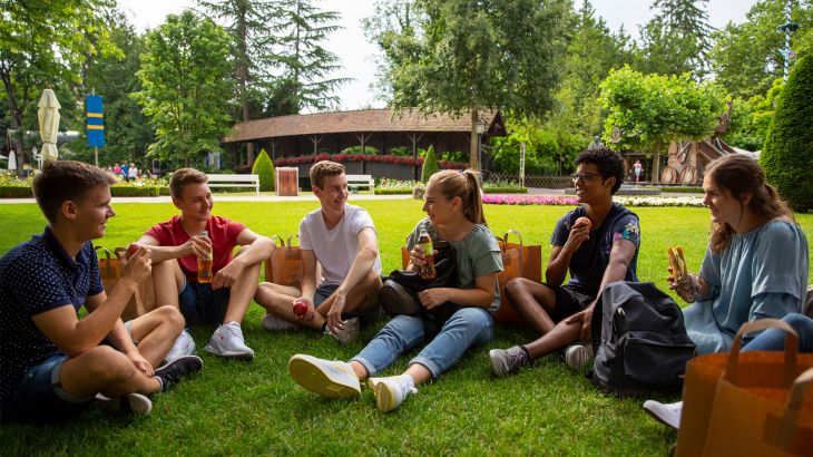 Schulklasse beim Picknick im Schlossgarten des Schloss Balthasar