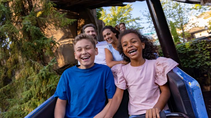 Eine Familie fährt mit dem Alpenexpress "Enzian" und lacht dabei