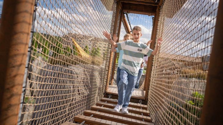 Zwei Kinder in einem Netztunnel auf dem Yomi Abenteuer Trail.
