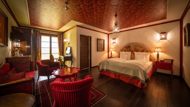 Juniorsuite Hotel El Andaluz Wohn- und Schlafzimmer mit Doppelbett, Tisch und Sitzmöglichkeiten