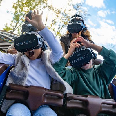Visitors wearing Coastiality glasses sit in the Alpenexpress 'Enzian' and enjoy the adventurous ride.
