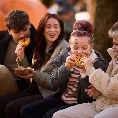 Eine vierköpfige Familie isst gemeinsam Donuts.