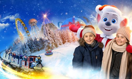Ed im weihnachtlichen Kostüm mit zwei Kindern vor der Silhouette des weihnachtlichen Europa-Park