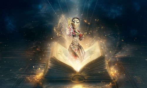 Marionette die aus einem Buch empor steigt